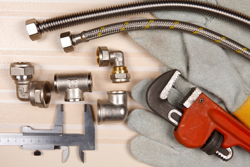 Plumber working on pipes in a Dalston home