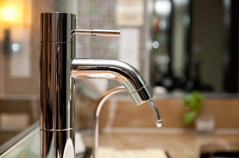 Leaking tap being repaired in Dalston